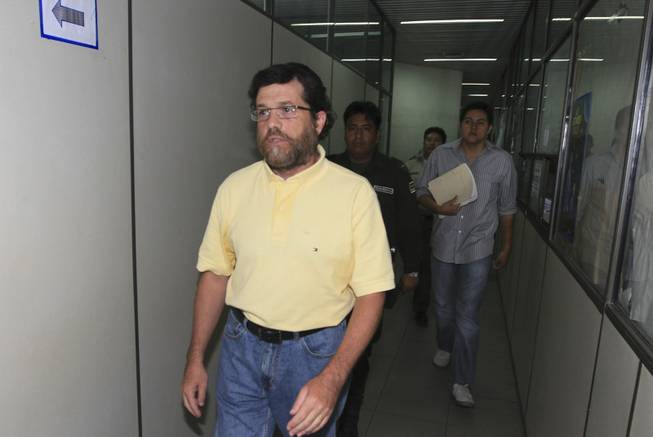 In this March 21, 2012, file photo, Jacob Ostreicher, a New York City businessman, left, arrives at a court to attend a hearing in Santa Cruz, Bolivia. The U.S. State Department says Ostreicher, who was detained the past 2 1/2 years in Bolivia on suspicion of money laundering, has arrived in the United States. Bolivian government officials said Monday that they didn't know anything about him possibly leaving.