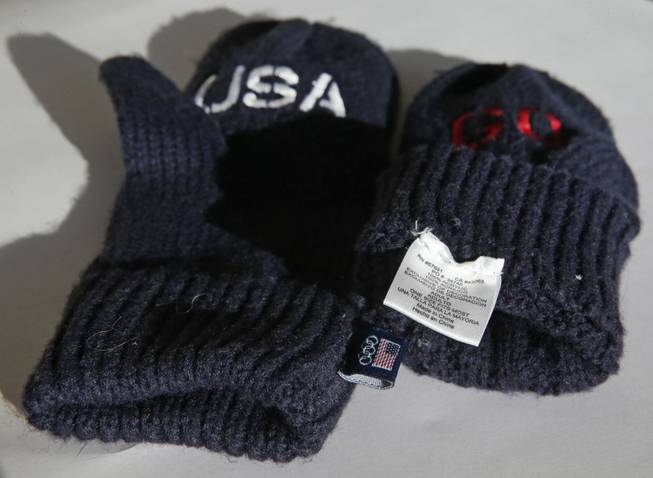 Embroidered mittens that the U.S. Olympic Committee are selling as part of a fundraiser are shown in Denver. The U.S. Olympic Committee is charging $14 a pair for the blue gloves that have the word "Go" embroidered in red on one mitten and "USA" on the other. The pair is also labeled with a tag on the inside that says the gloves are "Made in China." The foreign-made mittens are available at the USOC's official online shop of the U.S. Olympic Team.