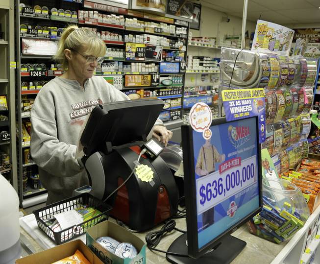 Holly Alfred prints out Mega Millions lottery tickets for a customer at Tobacco Plus Tuesday, Dec. 17, 2013, in Muncie, Ind. Two winning Mega Millions tickets were sold in California and Georgia, lottery officials said.