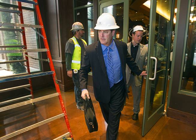 Shawn Ritchie, vice president of food and beverage for the Flamingo and the Quad, leads a hard hat tour of the new O'Sheas casino Tuesday Dec. 18, 2013. The casino is scheduled to open Dec. 27.