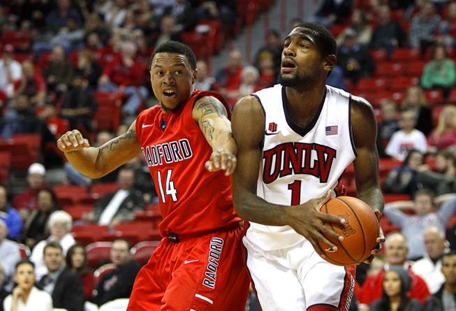Radford University's Justin Cousin covers UNLV Runnin' Rebels Roscoe Smith during the first game of the Continental Tire Las Vegas Classic at the Thomas & Mack Center in Las Vegas Wednesday, Dec. 18, 2013.