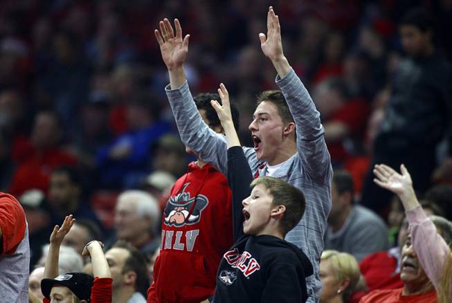 Fans call out for free T-shirts during the first game of the Continental Tire Las Vegas Classic between the UNLV Runnin' Rebels and the Radford University Highlanders at the Thomas & Mack Center Wednesday, Dec. 18, 2013.