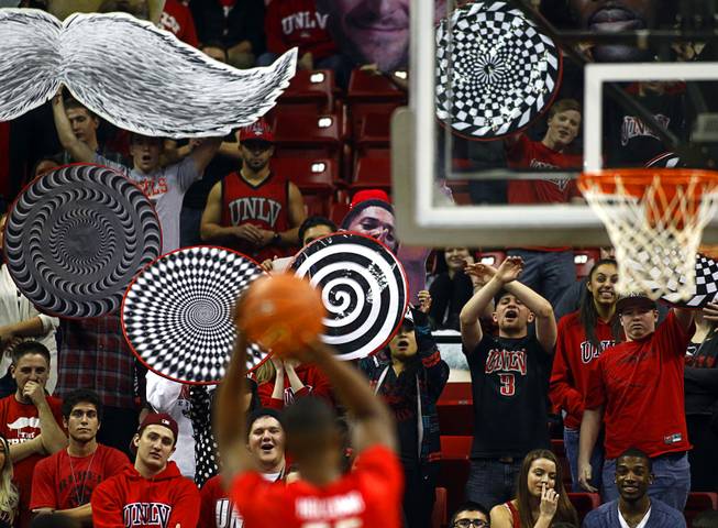 UNLV Runnin' Rebels fans try to distract a Radford University Highlander as he attempts a foul shot during the first game of the Continental Tire Las Vegas Classic at the Thomas & Mack Center Wednesday, Dec. 18, 2013.