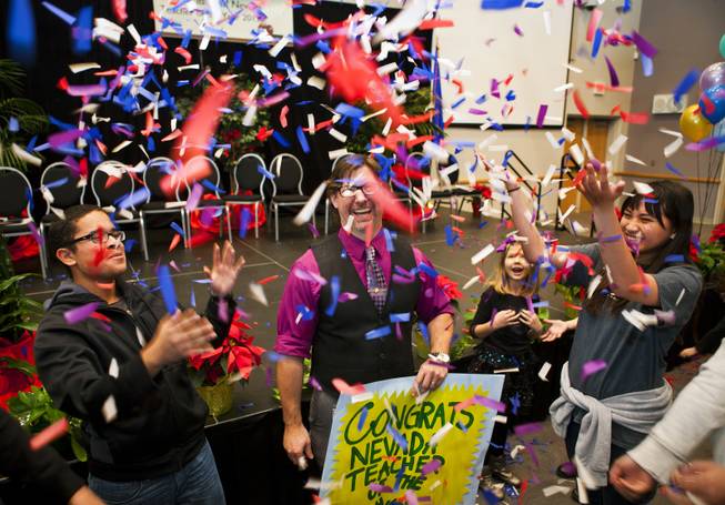 Northwest Career & Technical Academy teacher Jeff Hinton is photographed as former students shower him with confetti after receiving the Nevada Teacher of the Year Award on Wednesday, Dec. 18, 2013.