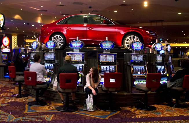 A cherry-red Audi on display atop a platform at the Luxor can be won by the right slot pull on Wednesday, Dec. 18, 2013.  Getting them in the casino and in place is quite the task.