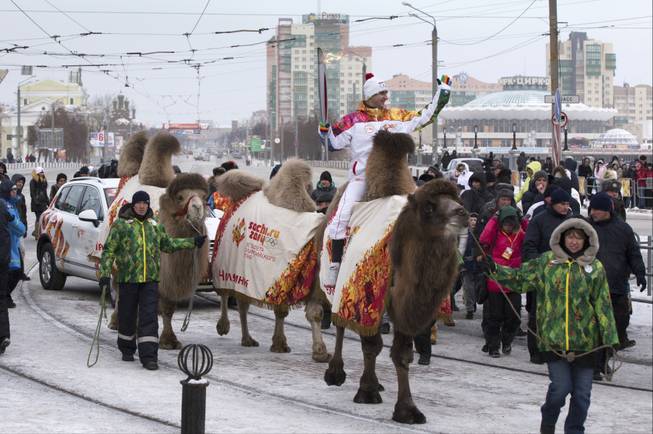 In a handout photo, Evgeny Zemskov, an Olympic torchbearer, rides a camel in Chelyabinsk, Russia, Dec. 17, 2013. The flame is being taken through all 83 of Russia's regions and to some extreme locales during a 40,389-mile torch relay to Sochi, the longest in Olympic history.