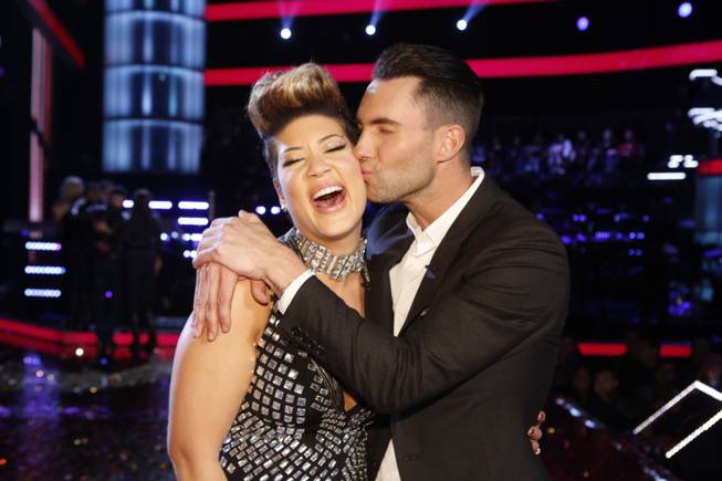 Maroon 5 frontman Adam Levine kisses Tessanne Chin on the cheek after Chin was announced the Season 5 winner of “The Voice” on NBC on Tuesday, Dec. 17, 2013, in Los Angeles.
