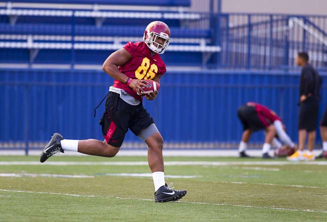 USC tight end and Bishop Gorman graduate Xavier Grimble runs with the ball after catching a pass during practice with the team at Bishop Gorman Thursday, Dec. 19, 2013. USC plays Fresno State in Saturday's Las Vegas Bowl.