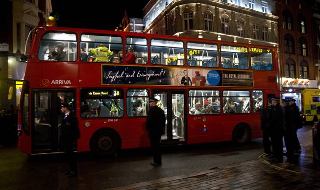 Shocked and injured theatergoers are transported to hospital in a commandeered London bus  following an incident  during a performance at the Apollo Theatre,  in London's Shaftesbury Avenue, Thursday evening, Dec. 19, 2013. 