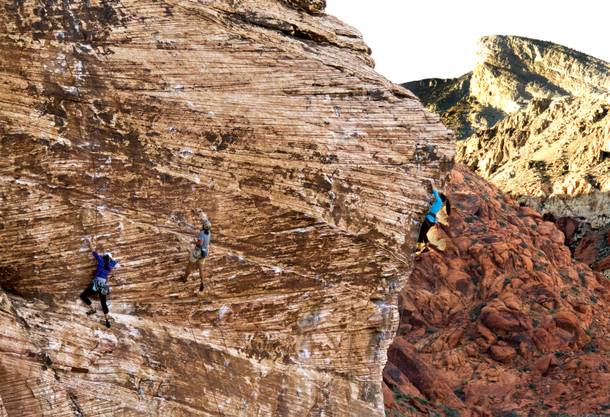 Climbers scale the rock face within the Red Rock Canyon National Conservation Area which encompasses 195,819 acres within the Mojave Desert, Tuesday, Nov. 11, 2013.