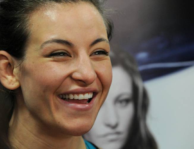 UFC womens bantamweight title contender Miesha Tate answers questions from reporters on after a short training session at the UFC Gym Friday, Dec. 20, 2013.