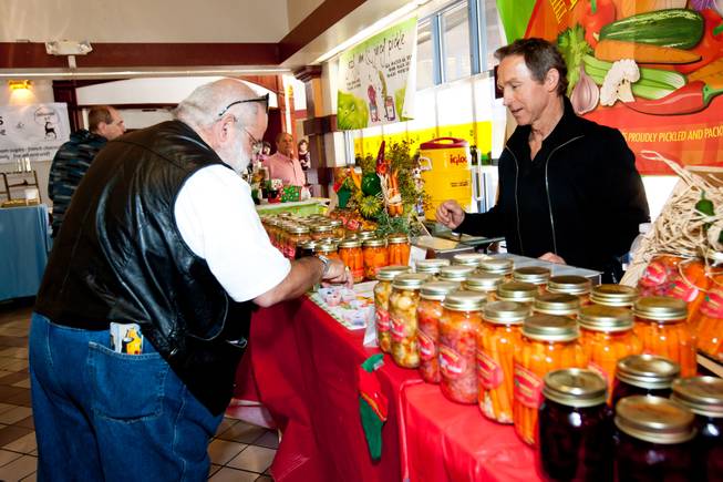 Carlos Mijares selects a sample in Nick Kreway's The Pickled Pantry booth at the Downtown Farmers' Market in Las Vegas Friday, December 20, 2013.