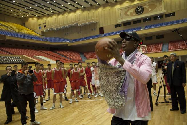 Former NBA basketball star Dennis Rodman takes a jump shot as he gives a training demonstration to North Korean basketball players in Pyongyang, North Korea on Friday, Dec. 20, 2013.