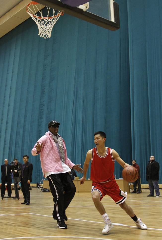 Former NBA basketball star Dennis Rodman plays one-on-one with  north Korean player during a basketball practice session in Pyongyang, North Korea on Friday, Dec. 20, 2013.