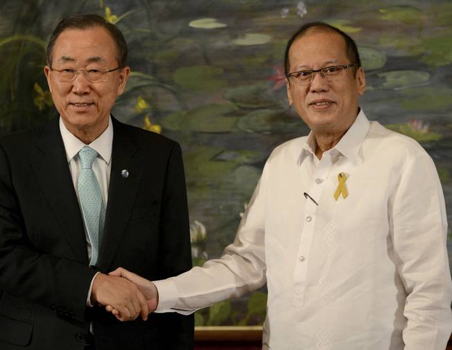 Philippine President Benigno Aquino III, right, shakes hands with United Nations Secretary-General Ban Ki-Moon as they pose for the photo during a courtesy call at Malacanang Palace in Manila, Philippines, on Saturday Dec. 21, 2013. Ban is in Manila to visit Tacloban City to see first-hand the devastation caused by Typhoon Haiyan, which slammed into central Philippine provinces Nov. 8, leaving a wide swath of destruction and killed thousands of people.