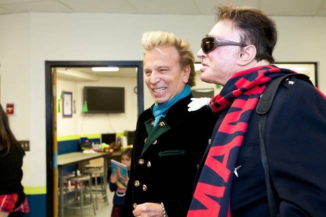 Siegfried and Roy smile as the children greet them with Christmas carols during the holiday party at the Boys and Girls Club at 2801 E. Stewart Avenue in Las Vegas December 20, 2013.