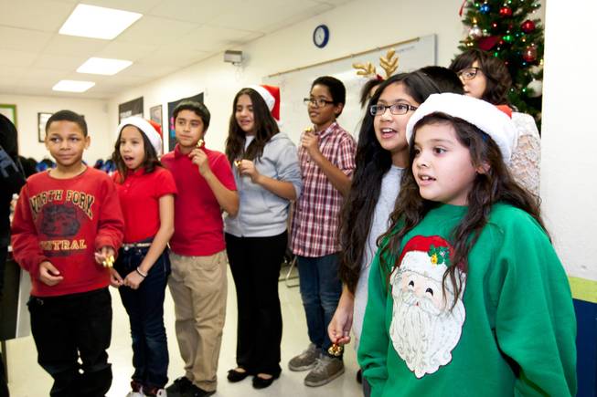 Sarita Ramirez, right, joins other children in singing Christmas carols to Siegfried and Roy during the holiday party at the Boys and Girls Club at 2801 E. Stewart Avenue in Las Vegas December 20, 2013.