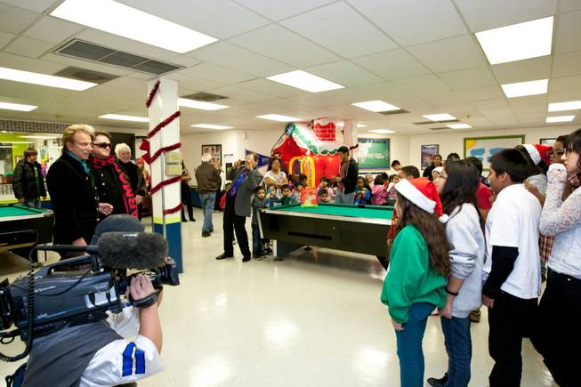 Siegfried and Roy are greeted with Christmas carols upon making their entrance into the holiday party at the Boys and Girls Club at 2801 E. Stewart Avenue in Las Vegas December 20, 2013.