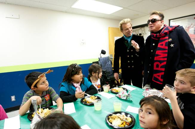 Siegfried and Roy wish the children a merry Christmas during the holiday party at the Boys and Girls Club at 2801 E. Stewart Avenue in Las Vegas December 20, 2013.