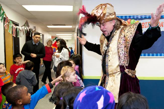 A magical genie surprises the children during the Christmas feast and holiday party provided by Siegfried and Roy at the Boys and Girls Club at 2801 E. Stewart Avenue in Las Vegas December 20, 2013.