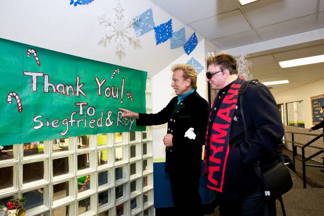 Siegfried and Roy admire the thank you sign made in their honor for providing the Christmas feast and holiday party at the Boys and Girls Club at 2801 E. Stewart Avenue in Las Vegas December 20, 2013.