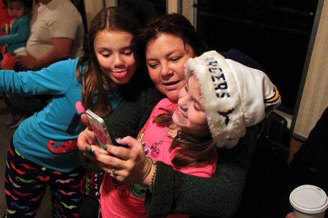 From left, Kyla, Gina and Abbi Whitlatch take a photo of themselves during the Nevada Southern Railway's "Pajama Train" ride Saturday, Dec. 21, 2013.