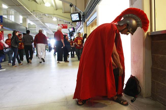 A USC fan who calls himself "Trojan Joe" gets ready for the Royal Purple Las Vegas Bowl between Fresno St. and USC Saturday, Dec. 21, 2013.