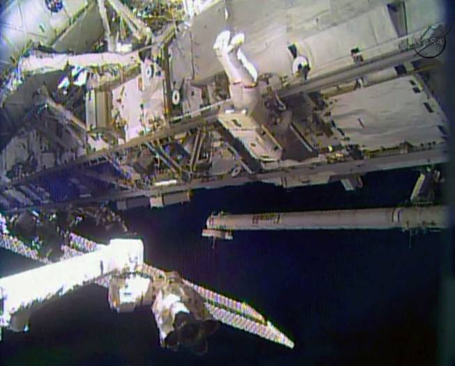In this image made from video provided by NASA, astronaut Rick Mastracchio performs a space walk outside the International Space Station on Saturday, Dec. 21, 2013. Mastracchio and Michael Hopkins ventured out of the station to try to revive a crippled cooling line.
