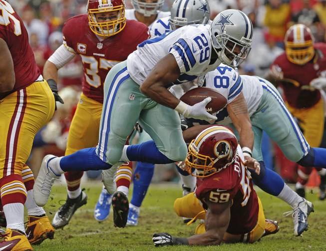 Dallas Cowboys running back DeMarco Murray (29) carries the ball into the end zone past Washington Redskins linebacker London Fletcher (59) for a touchdown during the first half of an NFL football game in Landover, Md., on Sunday, Dec. 22, 2013.