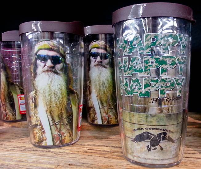 This Saturday, Dec. 21, 2013, photo shows items showing the image of Phil Robertson and his catchphrase "Happy, Happy, Happy" displayed at the Duck Commander store in West Monroe, La. The town is the setting for the popular "Duck Dynasty" series.