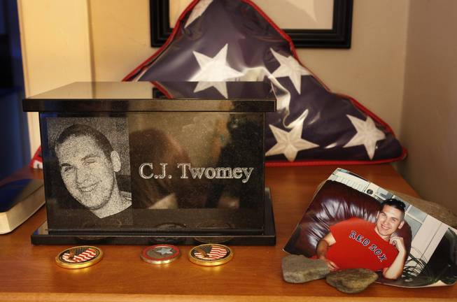 This Dec. 17, 2013, photo shows an urn containing the ashes of C.J. Twomey on a shelf at his parents' home in Auburn, Maine. C.J.'s mother, Hallie Twomey, is asking people to help scatter his ashes throughout the world so he can become part of the world he never got to see.