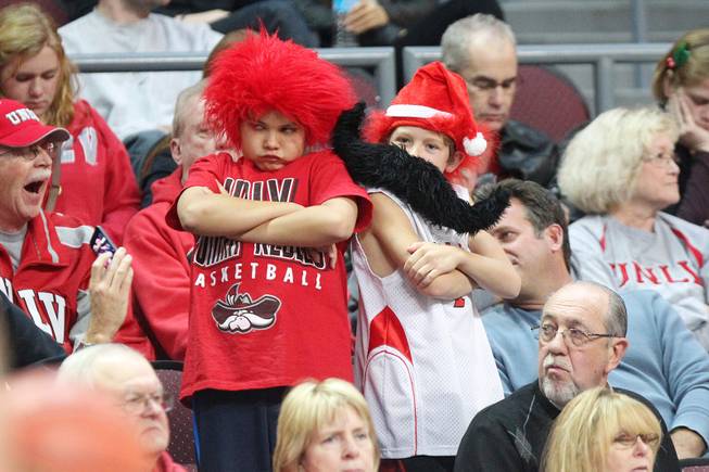 Two young UNLV fans dance to a song during a break in their game against Mississippi State at the Continental Tire Las Vegas Classic game Monday, Dec. 23 2013, at the Orleans Arena.