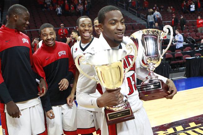 UNLV guard Deville Smith holds the Continental Tire Las Vegas Classic championship trophy and his MVP trophy Monday, Dec. 23 2013, at the Orleans Arena. UNLV beat Mississippi State 82-66.
