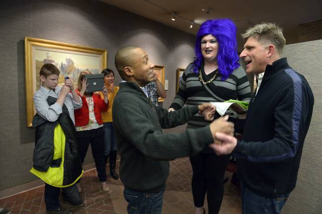 In this photo taken on Monday, Dec. 23, 2013, Greg Jaboin, left, expresses his excitement upon being declared married to his partner of 10-years, Steve Kachocki by officiant David Beach at the Salt Lake City County offices in Salt Lake City. 