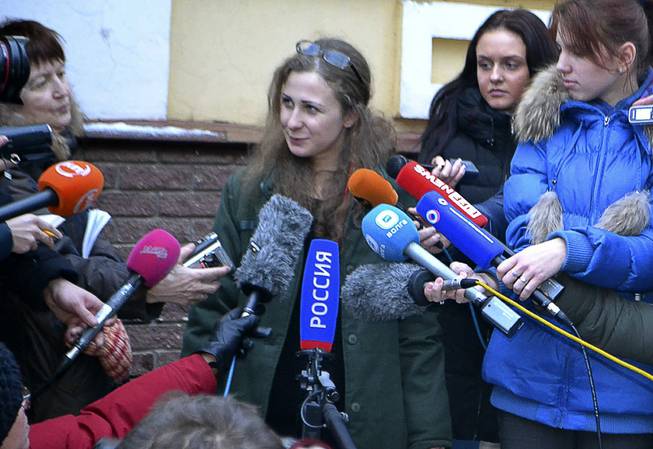 Maria Alekhina, second from left, a member of the Russian punk band Pussy Riot peaks to the media at the Committee against Torture after being released from prison, in Nizhny Novgorod, on Monday, Dec. 23, 2013.