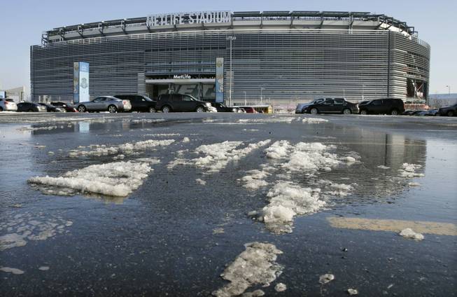 Snow and slush left from Tuesday's snowfall is seen outside MetLife stadium in East Rutherford, N.J., Wednesday, Dec. 18, 2013. Later Wednesday, at MetLife, officials demonstrated snow removal and melting machinery and outlined emergency weather scenarios and contingency plans for the Super Bowl in February.