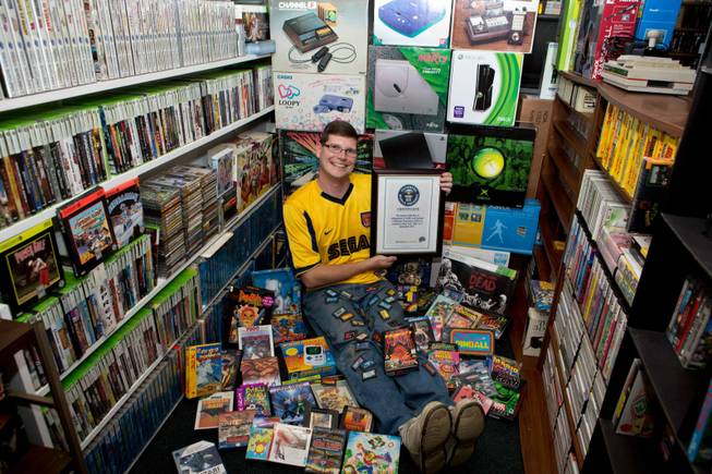 Michael Thomasson poses in the basement of his suburban Buffalo home, where he stores his collection of video games. Thomasson is featured in the just-released “Guinness World Records 2014 Gamer’s Edition” for having the largest collection of video games, 10,607. The number bests the previous record holder, Richard Lecce of Florida, who had 8,616 games in 2010.