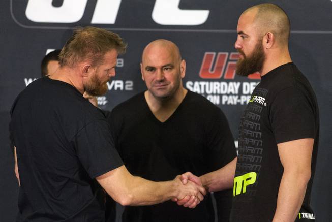Josh Barnett and Travis Browne shake hands as Dana White observes at the end of a press conference for the upcoming UFC168 at the MGM Grand Hotel & Casino with commentary from the top fighters on the card Thursday, Dec. 26, 2013.