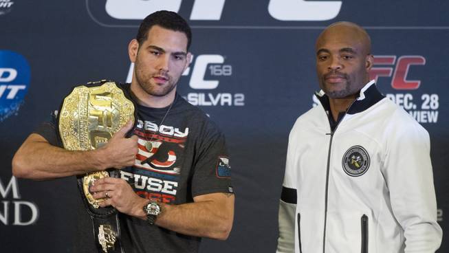 Chris Weidman and Anderson Silva pose near the end of a press conference for the upcoming UFC168 at the MGM Grand Hotel & Casino with commentary from the top fighters on the card Thursday,  Dec. 26, 2013.