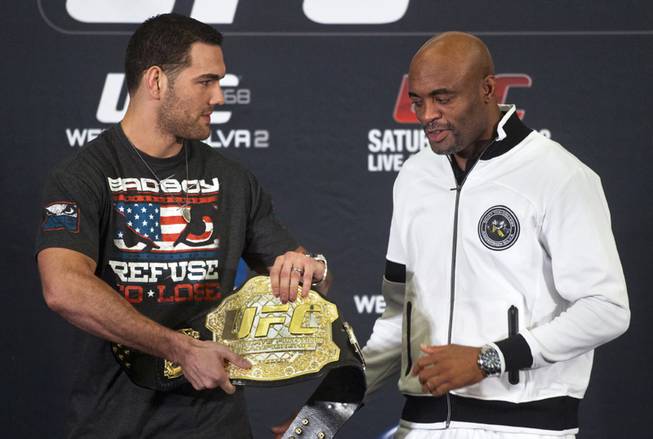 Fighter Chris Weidman offers his belt to opponent Anderson Silva ending the press conference for the upcoming UFC168 at the MGM Grand Hotel & Casino Thursday,  Dec. 26, 2013.
