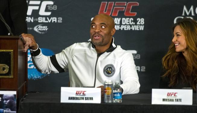 Anderson Silva makes a joke about he and Dana White's  relationship as Meisha Tate laughs during a press conference for the upcoming UFC168 at the MGM Grand Hotel & Casino with commentary from the top fighters on the card Thursday, Dec. 26, 2013.