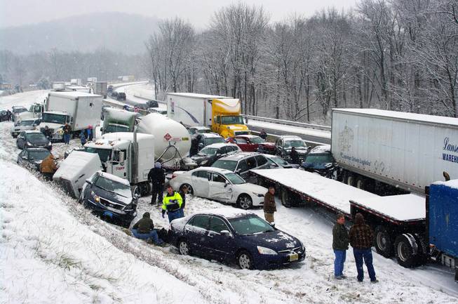 Vehicles are piled up at mile marker 286 on the Pennsylvania Turnpike, a mile outside Reading, Pa., on Thursday, Dec. 26, 2013. Portions of both the Pennsylvania Turnpike and Interstate 78 were shut down in snowy eastern Pennsylvania Thursday after chain-reaction pileups involved dozens of vehicles on slippery roads.