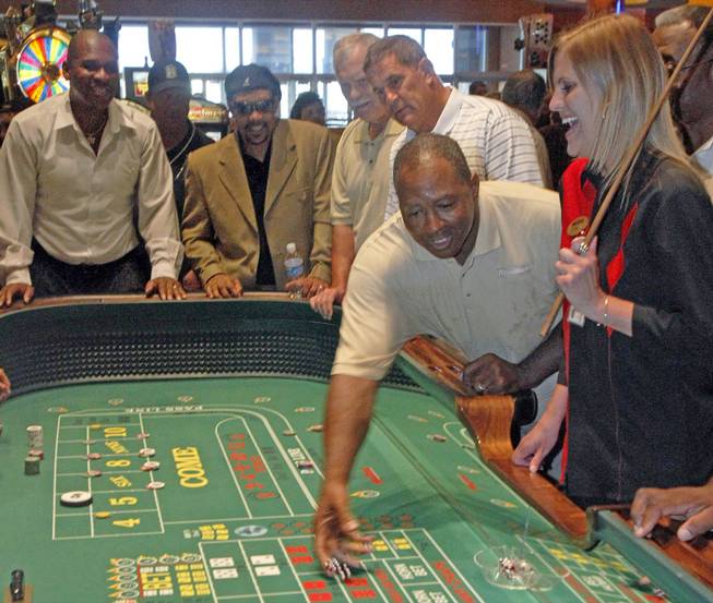 From left, former Steelers' Mike Merriweather, Louis Lipps, Jerry Mullins and John Banascak watch former Steeler Robin Cole, right, throw dice at a mock craps game at the Meadows Racetrack and Casino in Meadowlands, Pa., July 8, 2010. 