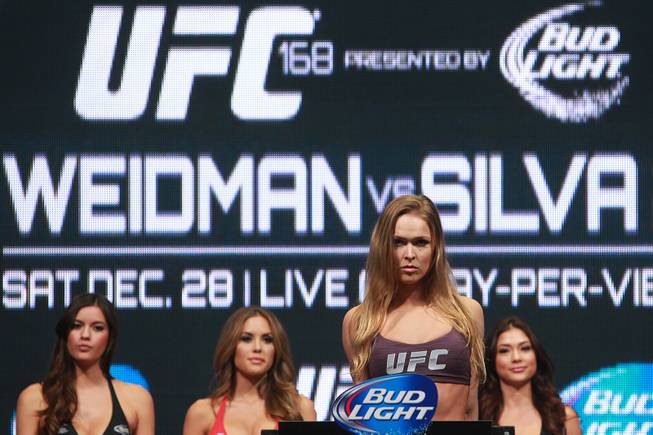 Ronda Rousey stands on the scale during the weigh in for UFC 168 Friday, Dec. 27, 2013 at the MGM Grand Garden Arena.