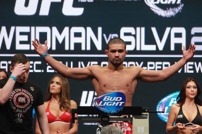 Diego Brandao holds his arms out after coming in seven pounds overweight during the weigh in for UFC 168 Friday, Dec. 27, 2013 at the MGM Grand Garden Arena.