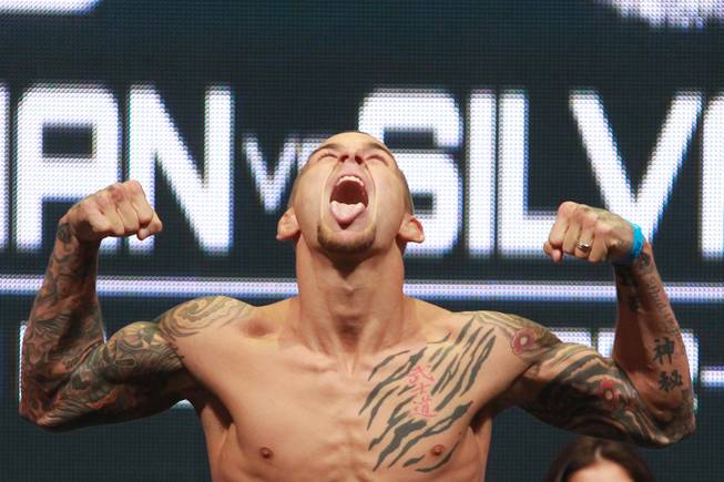Dustin Poirier yells after making weight for his fight against Diego Brandao during the weigh in for UFC 168 Friday, Dec. 27, 2013 at the MGM Grand Garden Arena.