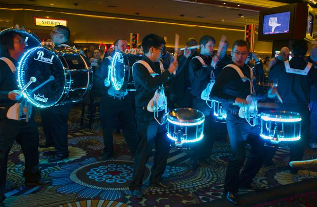 A lighted drum corps plays as part of the opening of Beachers Madhouse MGM Grand Hotel & Casino on Friday, Dec. 27, 2013.