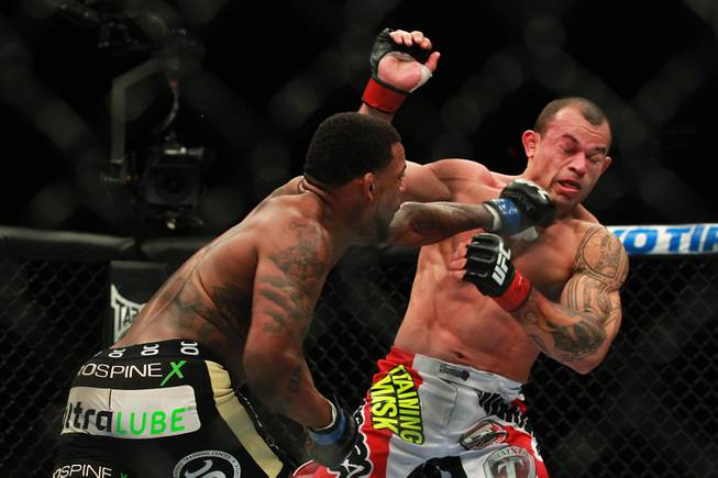 Michael Johnson hits Gleison Tibau with a left at UFC 168 Saturday, Dec. 28, 2013 at the MGM Grand Garden Arena.