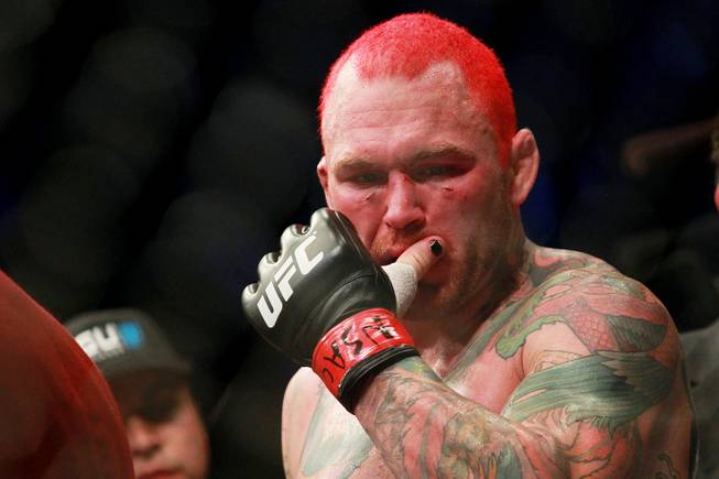 Chris Leben wipes his mouth after being defeated by Uriah Hall. at UFC 168 Saturday, Dec. 28, 2013 at the MGM Grand Garden Arena.