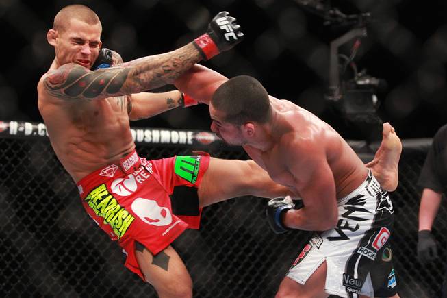 Dustin Poirier is hit with a right from Diego Brandao at UFC 168 Saturday, Dec. 28, 2013 at the MGM Grand Garden Arena.